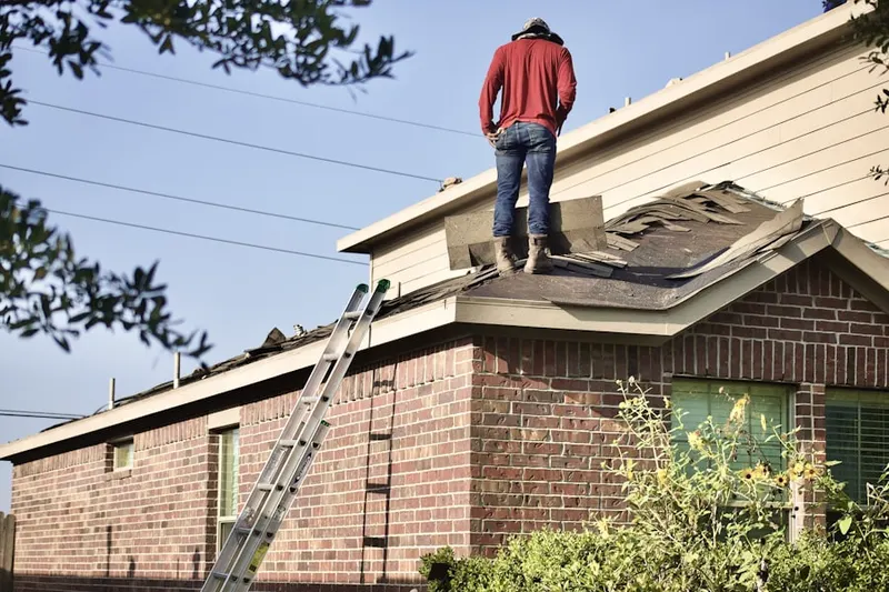 Professional roofer working on a residential roof in Saint Louisville